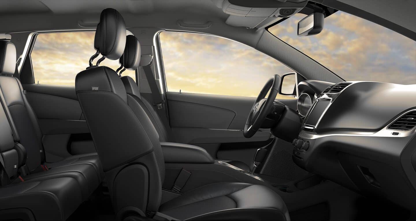 Display The interior of the 2020 Dodge Journey showing the first two rows of seating.