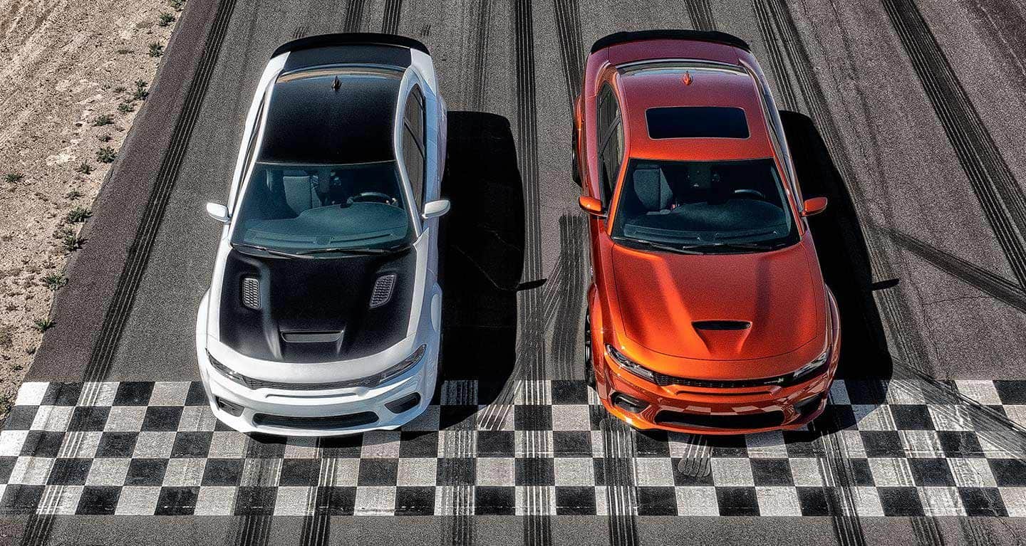 An overhead view of two widebodies on a track-a 2022 Dodge Charger SRT Hellcat Widebody and a Scat Pack Widebody.