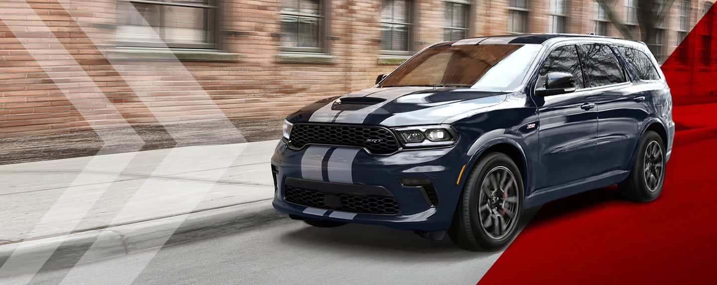The 2023 Dodge Durango in black exterior paint with white dual stripes on its hood and roof.