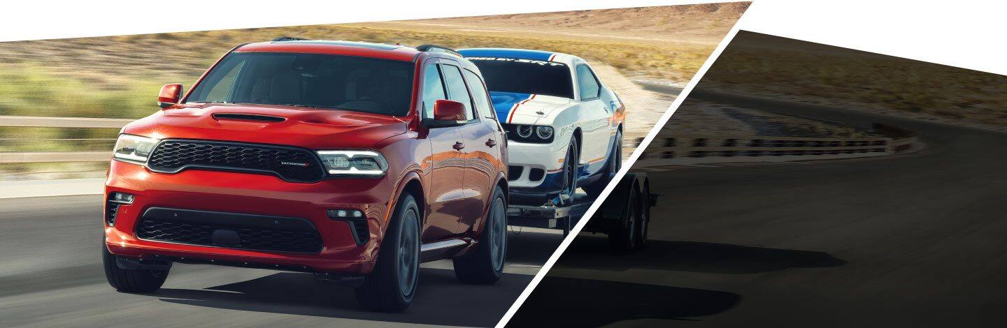 The 2021 Dodge Durango R/T towing a Dodge Challenger on an open road.
