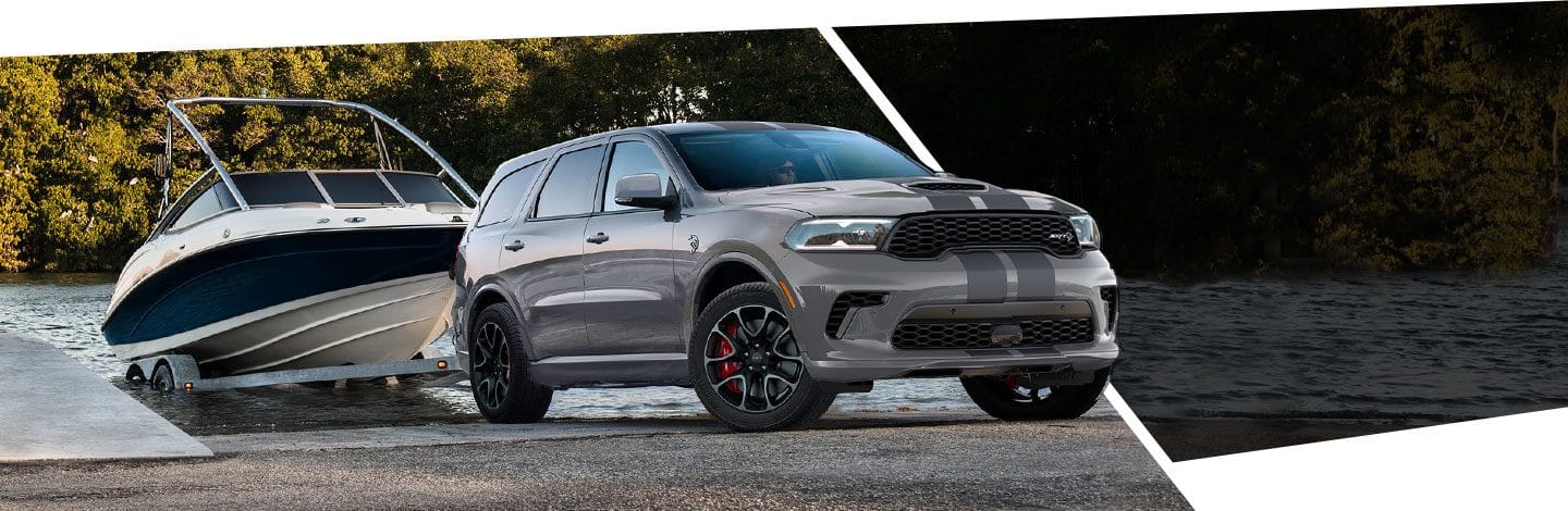 The 2021 Dodge Durango SRT towing a boat out of the water.