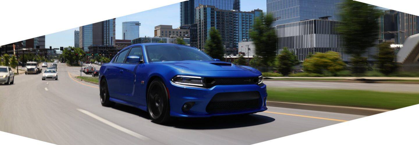 The 2020 Dodge Charger being driven on a city street.