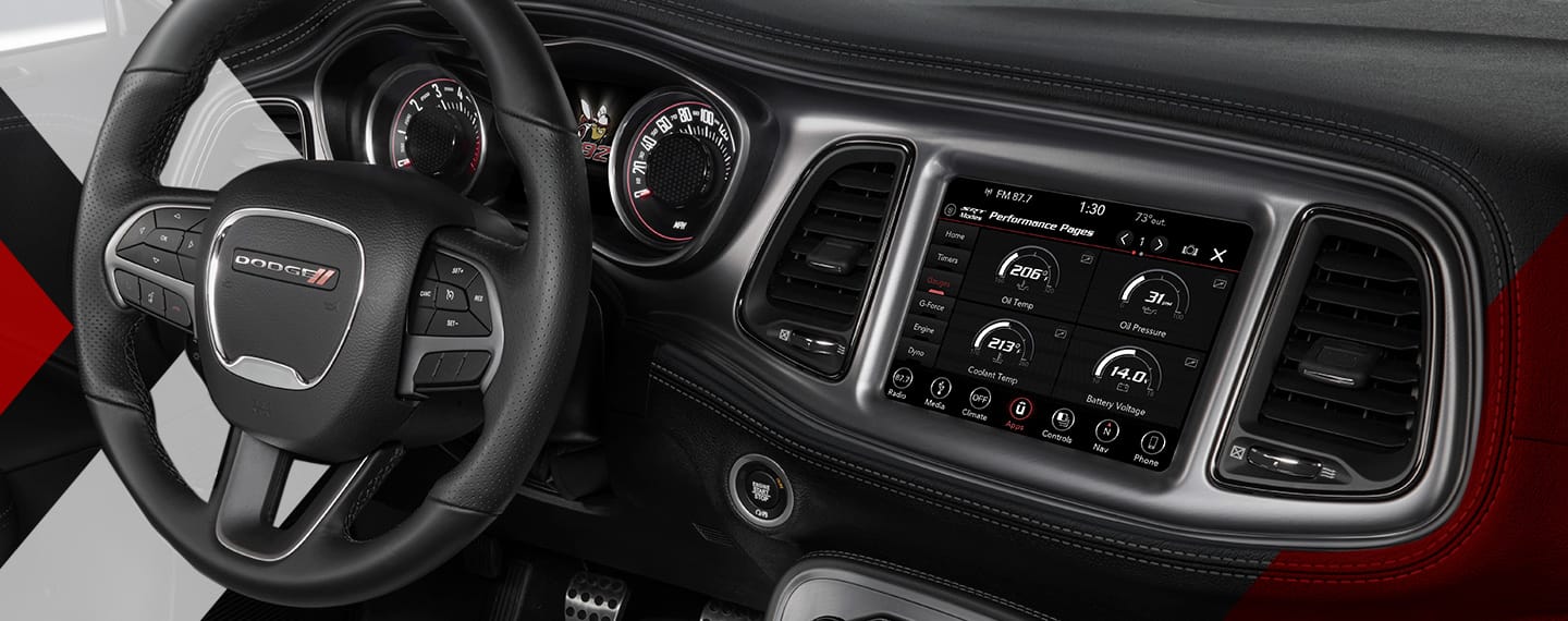 The interior of the 2023 Dodge Challenger focusing on the steering wheel, Digital Cluster and Uconnect touchscreen.