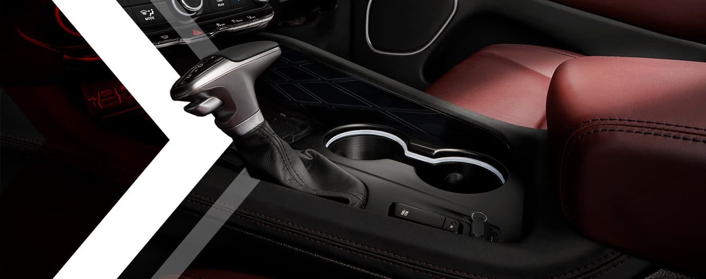 A close-up of the shifter and cup holders in the center console of the 2023 Dodge Durango.