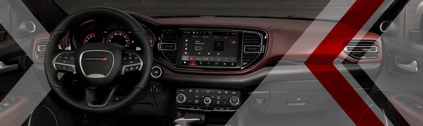 A close-up of the steering wheel, touchscreen, climate controls and dashboard in the 2023 Dodge Durango.