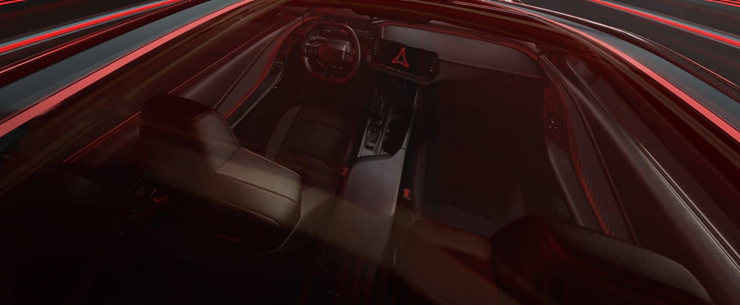The passenger compartment of a 2024 Dodge Daytona BEV from the rear, focusing on the front seat area.