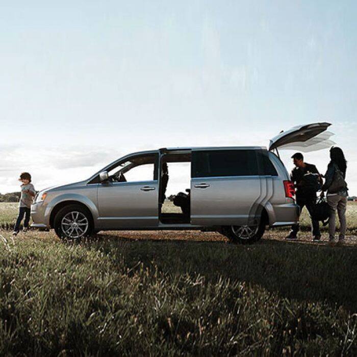 Exterior with power sliding side doors and power liftgate opened. 