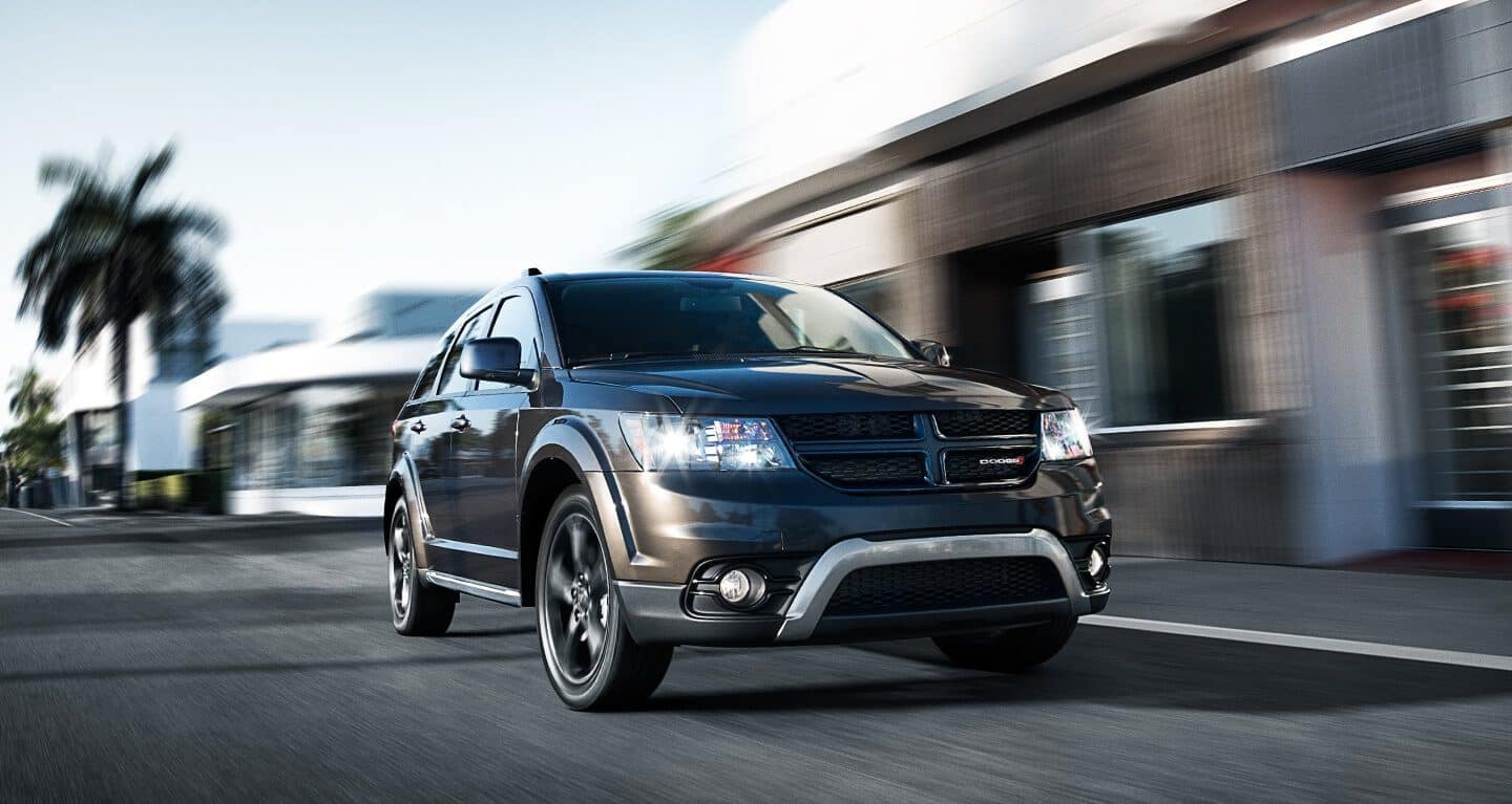 Display The 2020 Dodge Journey being driven through the city.