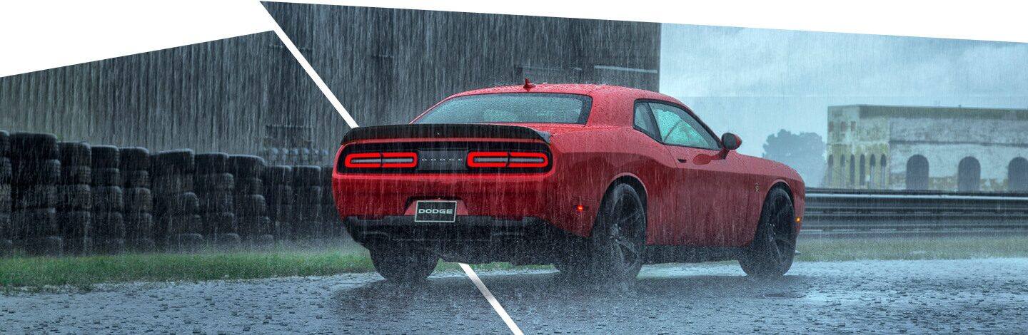 A 2021 Dodge Challenger SRT Hellcat being driven in pouring rain.