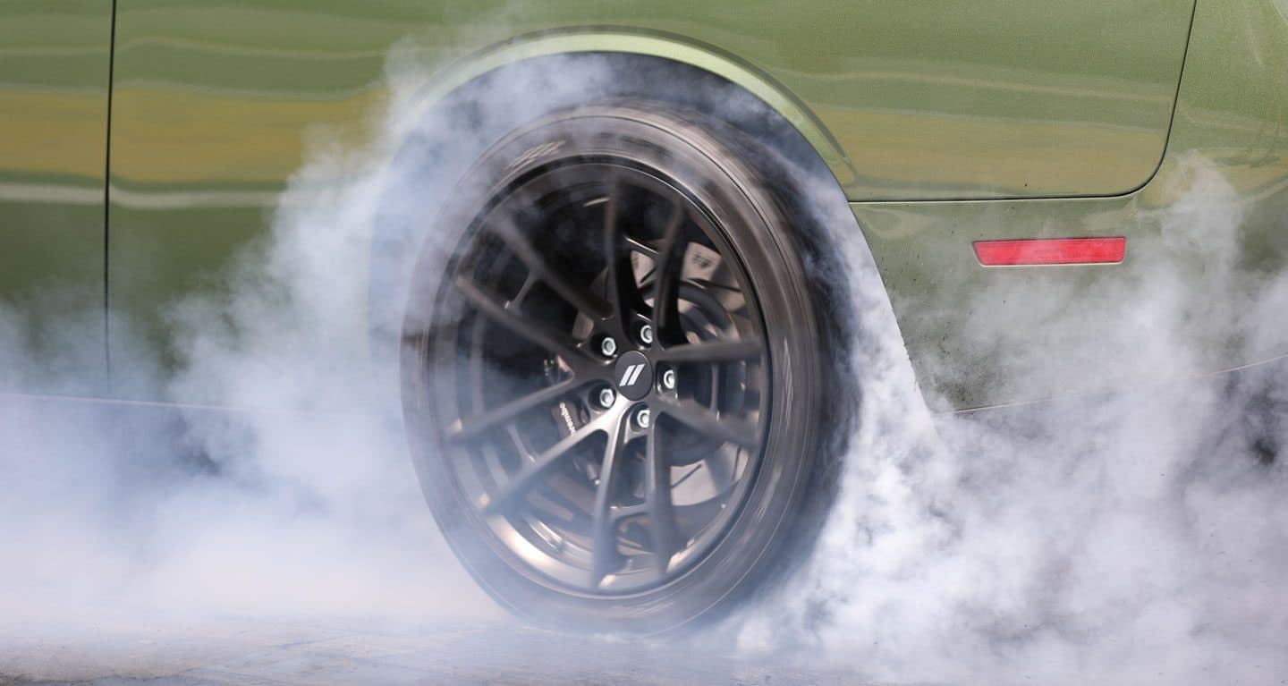 A cloud of dust rising from the spinning wheel on the 2021 Dodge Challenger 1320.