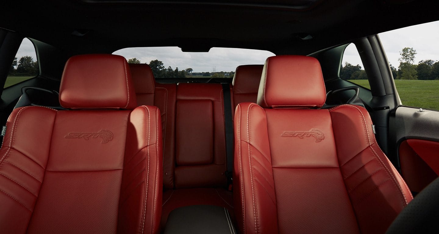 Display View of the red leather-trimmed front seats in a 2022 Dodge Challenger SRT.