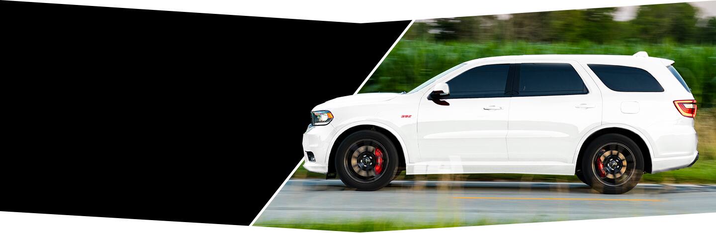 The 2022 Dodge Durango SRT 392 drives past a blurred background.
