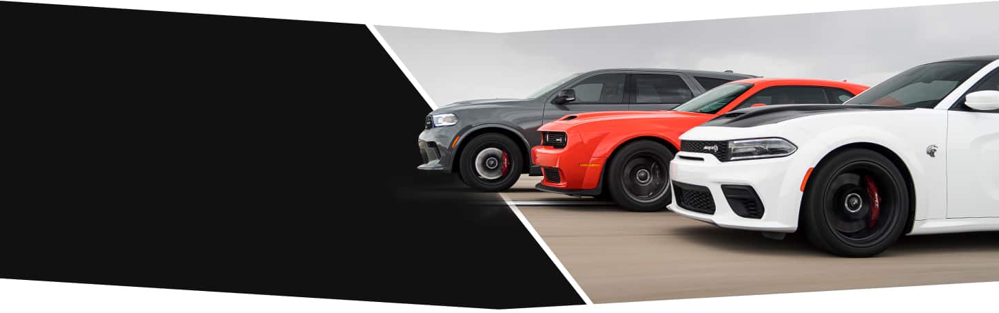 A 2022 Dodge Durango, Charger and Challenger on a track.