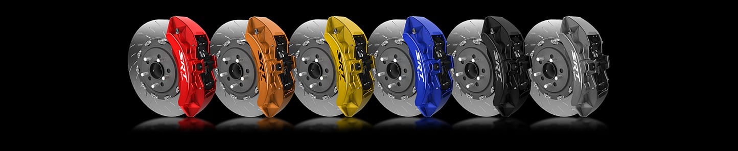 A lineup of brake calipers in red, orange, yellow, blue, black and gray.