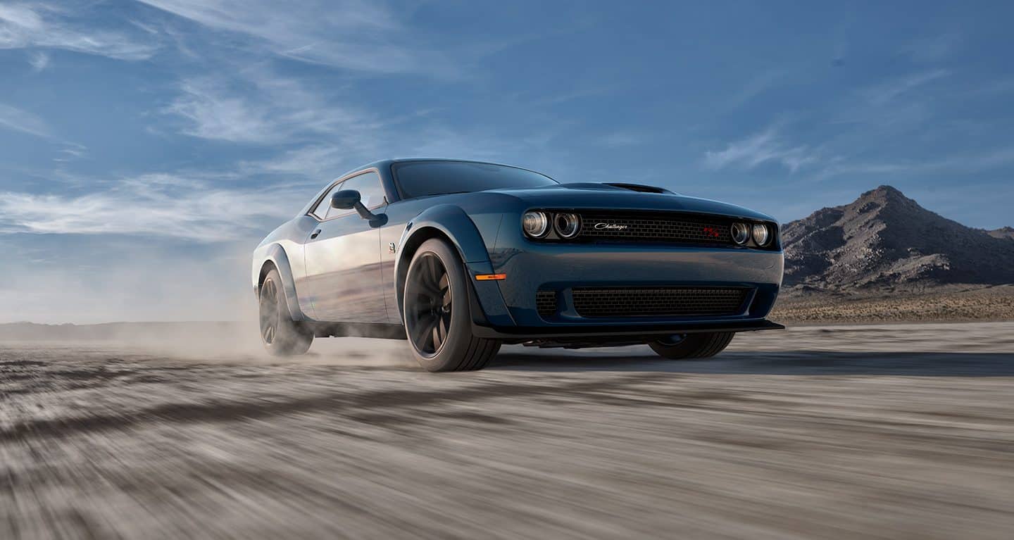 Display A low-lying angle of a 2023 Dodge Challenger R/T being driven on a track.