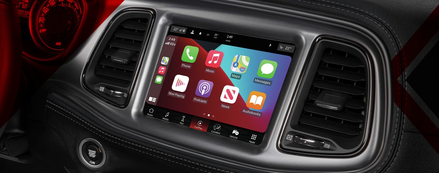 The Uconnect touchscreen in the 2023 Dodge Challenger displaying a series of Apple CarPlay selections.