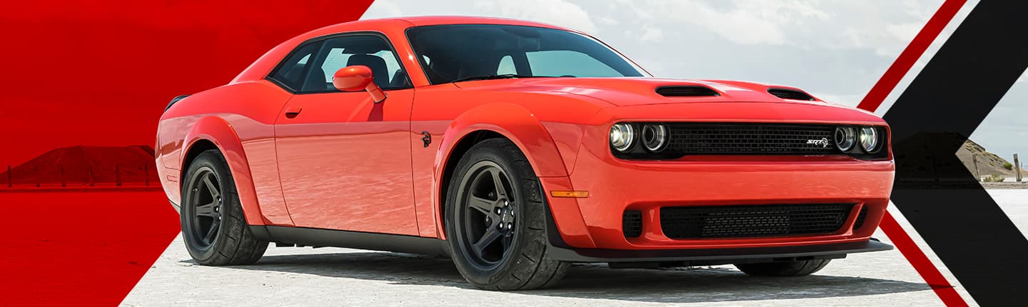 An angled passenger-side profile of a red 2023 Dodge Challenger SRT Super Stock parked on a track.