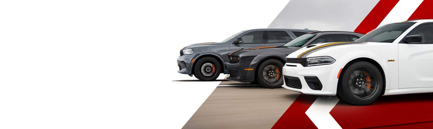 Three Dodge models parked in a staggered line. From left to right: A 2023 Dodge Durango SRT, a 2023 Dodge Challenger SRT Hellcat and a 2023 Dodge Challenger Scat Pack.