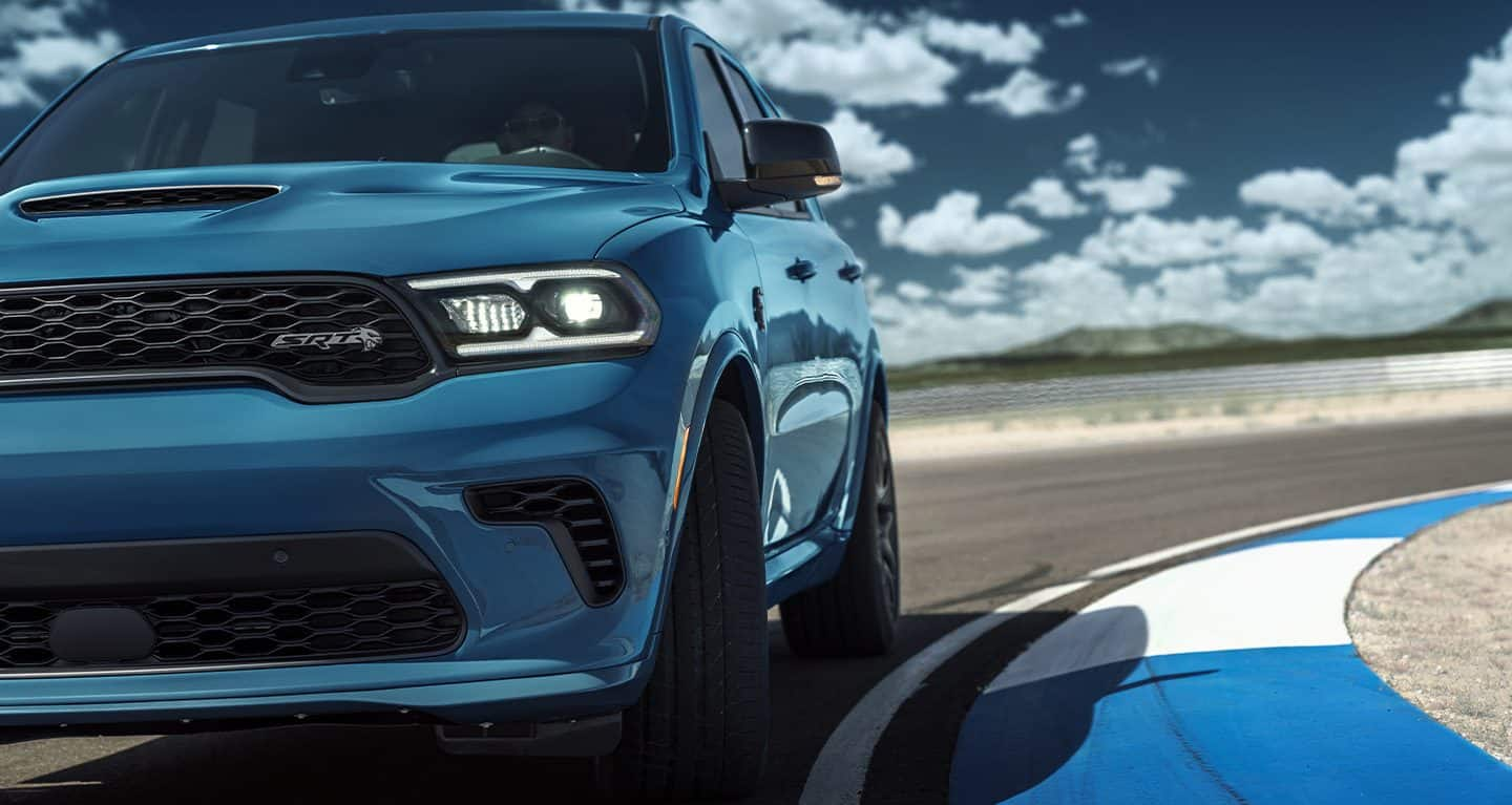 Display A close-up of the front of the 2023 Dodge Durango SRT 392 with black stripes on the hood.