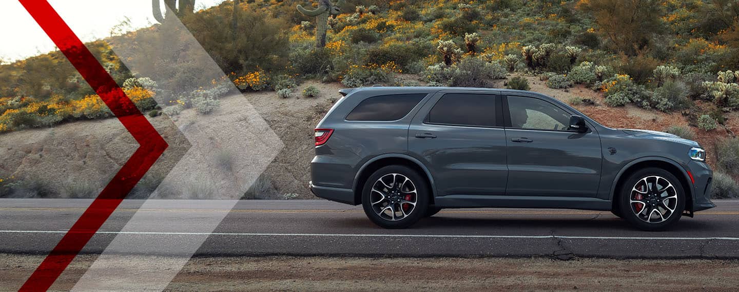 A side profile of the 2023 Dodge Durango parked on a desert road.
