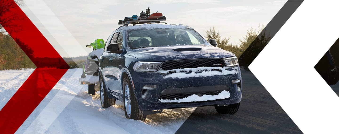 A snow-covered 2023 Dodge Durango on a snowy road