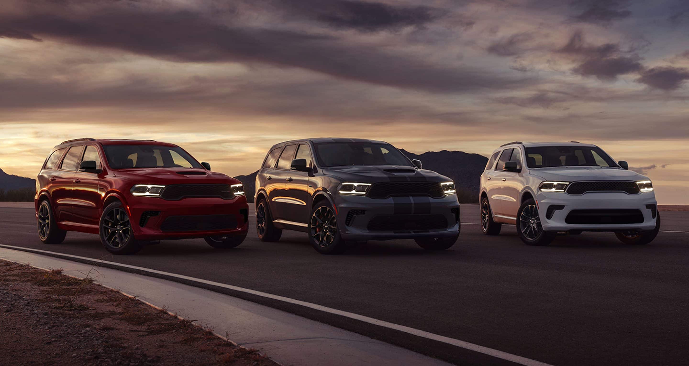 2024 Dodge Durango fleet parked in front of mountain range.