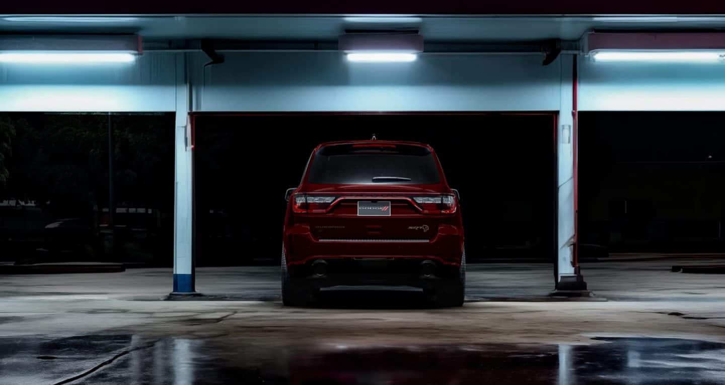 Display A rear angle of a red 2026 Dodge Durango SRT Hellcat in a lighted parking structure.