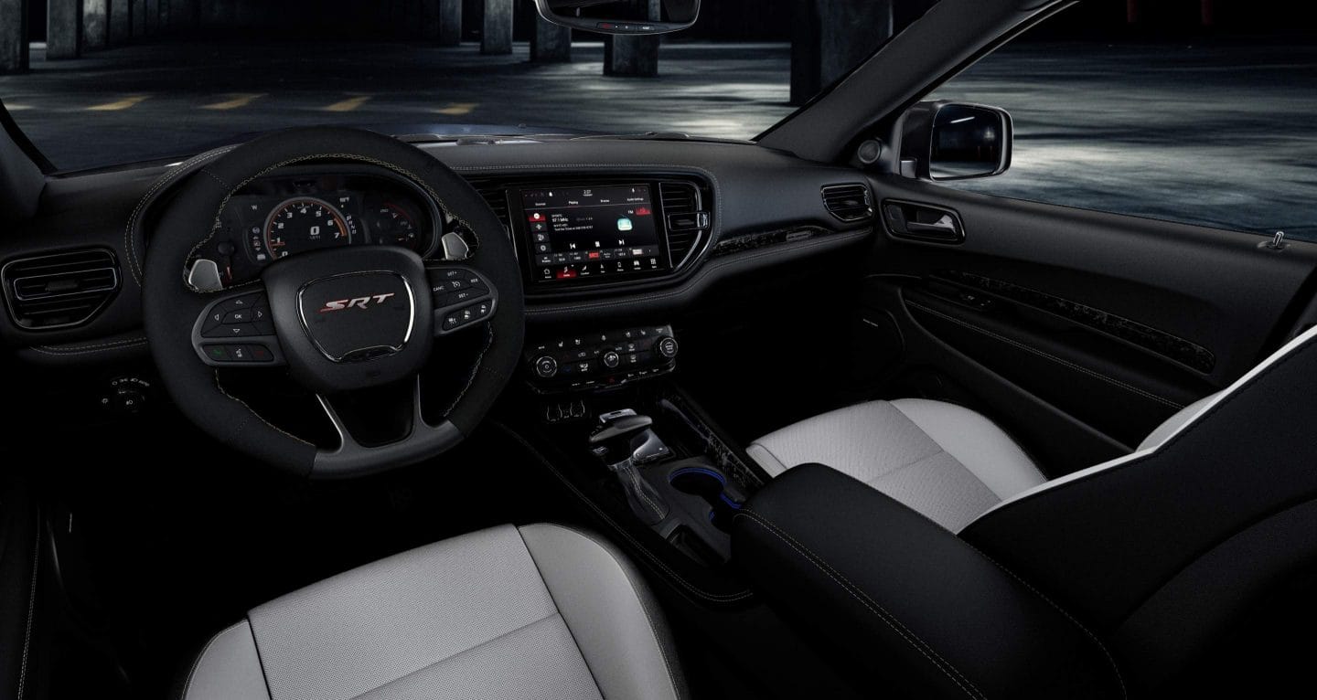 Display The steering wheel, Digital Cluster Display, Uconnect touchscreen and front seats in a 2026 Dodge Durango SRT Hellcat.