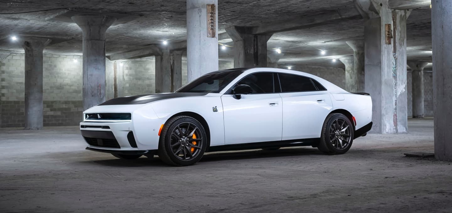 A white 2027 Dodge Charger Daytona Scat Pack with a black hood insert.