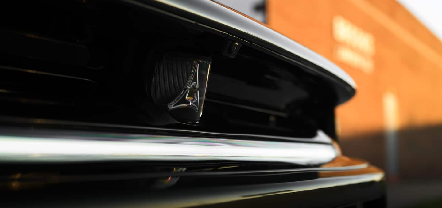 The rear spoiler on a white 2027 Dodge Charger Scat Pack.