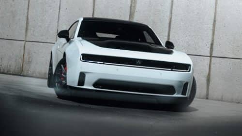 A white 2027 Dodge Charger Daytona Scat Pack with a black hood insert.