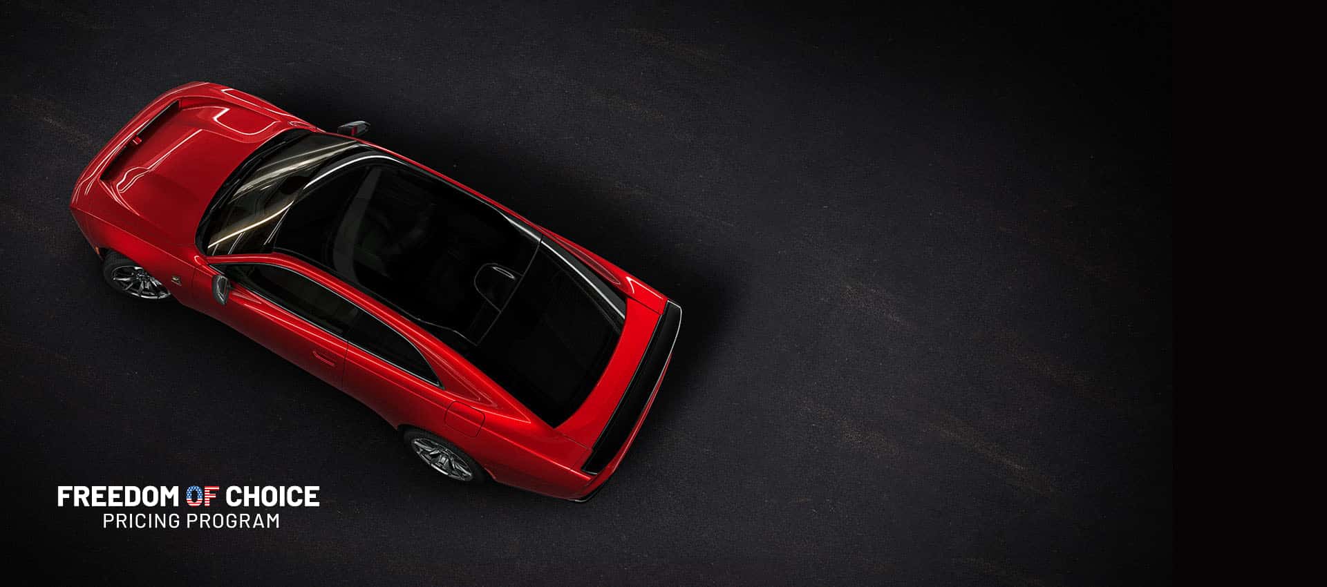 An overhead angle of a red 2024 Dodge Next-Gen Charger Scat Pack highlighting its panoramic glass sunroof. Freedom of choice Sales Event.