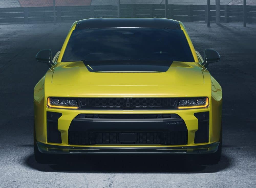 Front view of a yellow 2027 Dodge Charger Super Bee with a black hood