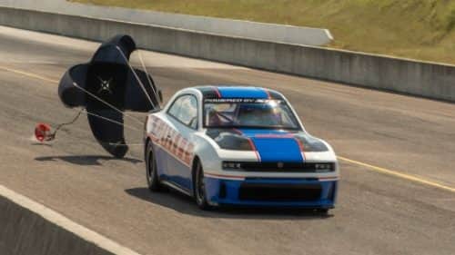 A white 2027 Dodge Charger Daytona Scat Pack with a black hood insert.