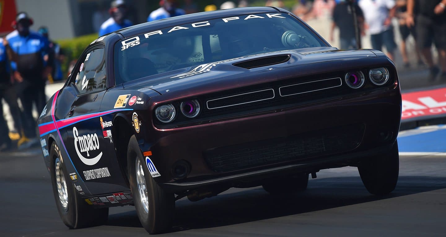 Display A black Pro Stock Super Street Challenger with Drag Pak emblazoned on its windshield.