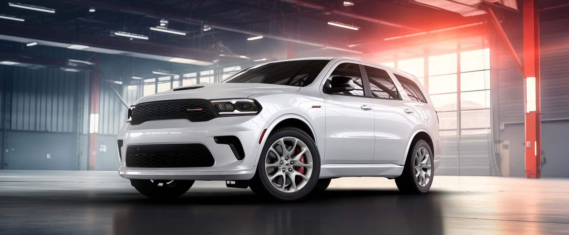 A white 2026 Dodge Durango R/T 392 parked in a warehouse.